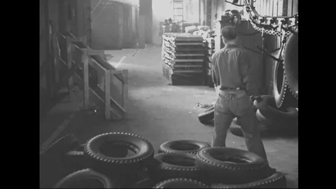 Scenes of men hang tyres and move tyres on production line of factory - 1939 Stock Footage 101983388