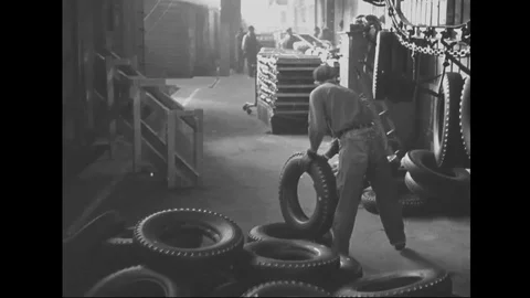 Scenes of men hang tyres and move tyres on production line of factory - 1939 Stock Footage 101983394