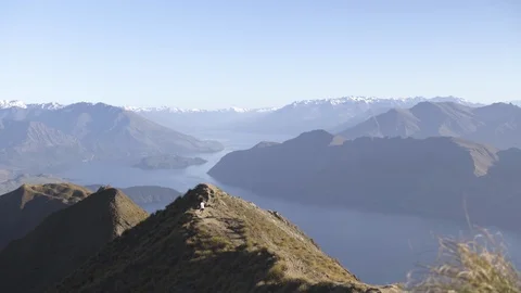 Scenes of mountain ranges and man walking on the mountain train Stock Footage 95007196