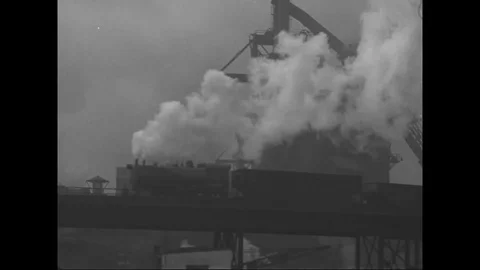 Scenes of steam train moves on the railroad and exterior of steel factory - 1939 Stock Footage 101789625