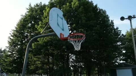 Scenes from the Suburbs - a basket ball net in any empty play ground Stock Footage 22004986