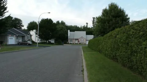 Scenes from the Suburbs - looking down a hedge at suburban homes Stock Footage 22007625