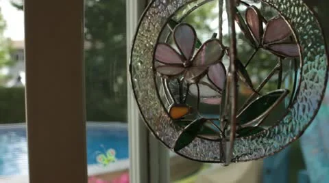 Scenes from the Suburbs - a stained glass chime hanging in a doorway. Stock Footage 22023341