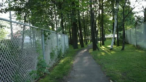 Scenes from the Suburbs - walk into the trees of a small park Stock Footage 22009592