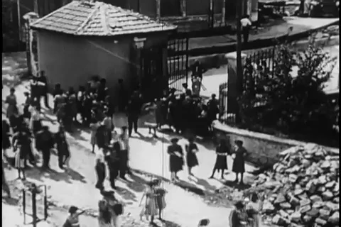 Scenes of workers leave mill and shopkeepers seated at roadside stalls - 1952 Video stock 105688818