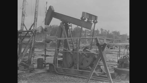 Scenes of workers look inside oil well frame and operation in oil refinery- 1954 Stock Footage 96023964
