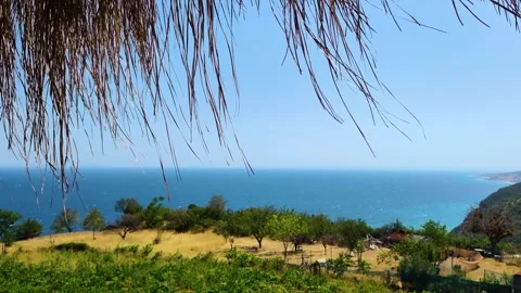 Scenic Aegean Sea View from a Rustic Thatched Roof Hut on a Sunny Summer Day Vídeos de archivo 333151352