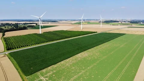 Scenic aerial drone view of wind trubines and green and yellow fields in France Stock Footage 290774445