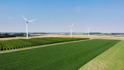 Scenic aerial drone view of wind trubines and green and yellow fields in France Stock Footage 290777086