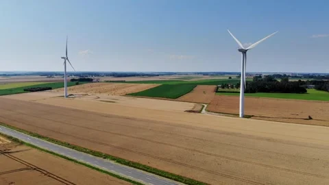 Scenic aerial drone view of wind trubines and green and yellow fields in France Stock Footage 290777205
