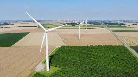 Scenic aerial drone view of wind trubines and green and yellow fields in France Stock Footage 290778970