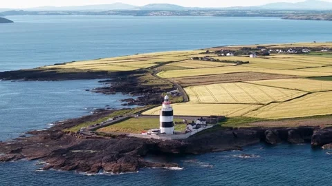 Scenic aerial of Hook Head Lighthouse overlooking the Atlantic coast, Ireland Stock Footage 340256875
