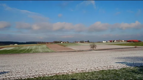 Scenic Aerial Pan Over Fields in Germany with Light Snow and Blue Sky Stock Footage 305186837
