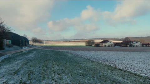 Scenic Aerial Pan Over Fields in Germany with Light Snow and Blue Sky Stock Footage 305193483