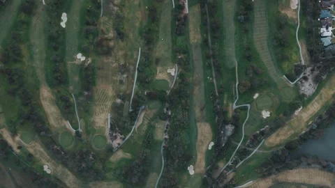 Scenic aerial top-down view of a golf course with fairways Vidéo 342574004