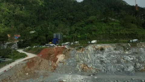 Scenic Aerial View of Mining Operations Surrounded by Lush Green Mountains and Stock Footage 316450745