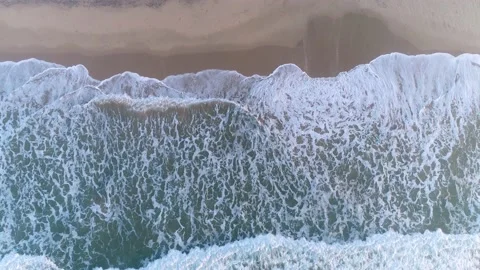 Scenic aerial view of ocean waves on a prestine sandy beach, southern Africa Видео 136430091