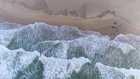Scenic aerial view of ocean waves on a prestine sandy beach, southern Africa Stock Footage 136430473