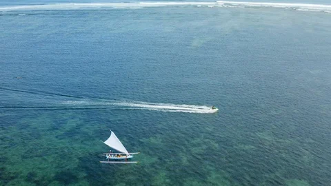 Scenic aerial view of older pair on their vacation sailing in Balinese boat Stock Footage 123734645