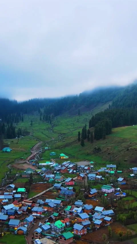Scenic aerial view of a remote mountain village in the valley Vídeos de archivo 336718705