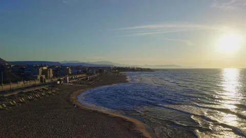 Scenic aerial view of sandy beach and coastal town at sunrise in Crete Greece Stock Footage 337405149