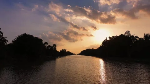 Scenic aerial view of sunset over tranquil river and silhouetted trees Stock Footage 343606630