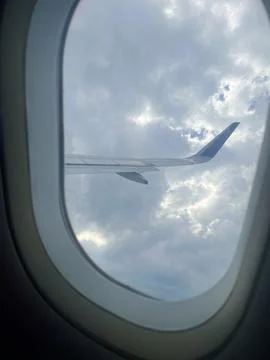 Scenic Airplane Window View of Clouds and Blue Sky Stock Photos