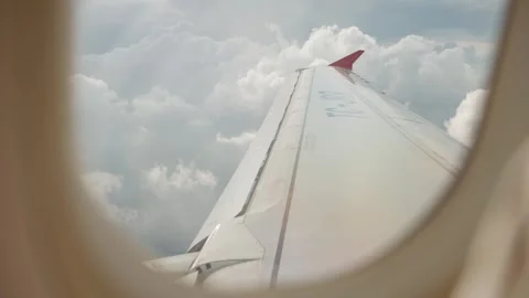 Scenic Airplane Window View of Wing and Moving Clouds in the Sky Vídeos de archivo 346105294