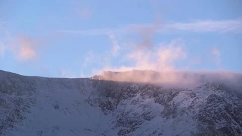 Scenic background of low cloud and snow flurries over a mountain ridge 動画素材 233298151