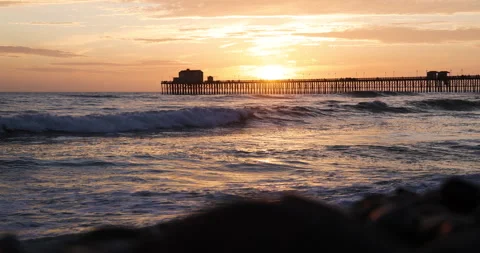 Scenic beach sunset with pier in background slow motion 4k 120fps Stock Footage 151937308