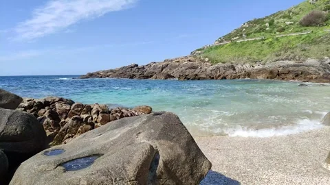 A scenic beach video featuring rugged rocks along the shore Stock Footage 305307649