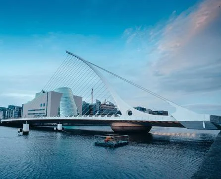 Scenic Bridge Over River with Modern Cityscape and Waterfront Skyline Stock Photos