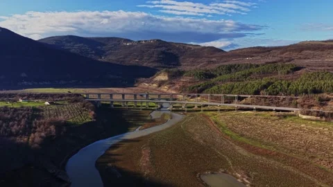 Scenic bridge over river in rural area with hills in background 動画素材 336547273