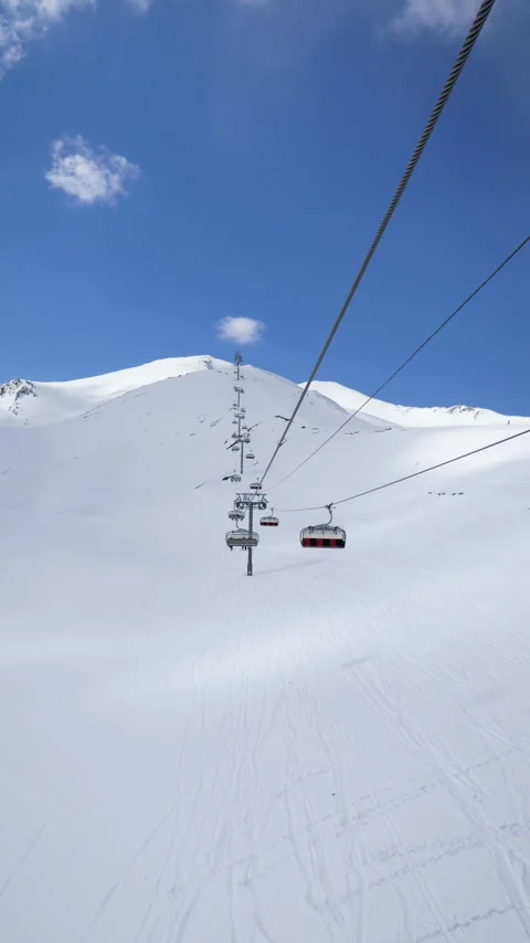 Scenic cable car ride ascending snowy mountain peak Stock Footage 342792572
