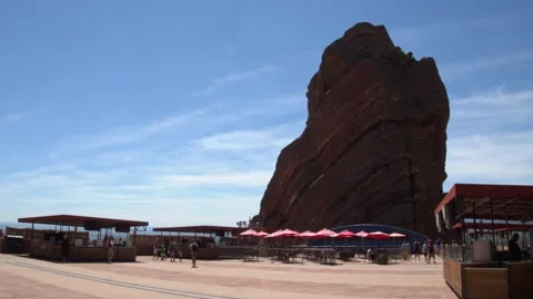 Scenic Cafe Resting In Shadow Of Large Monolithic Rock Stock Footage 156210529
