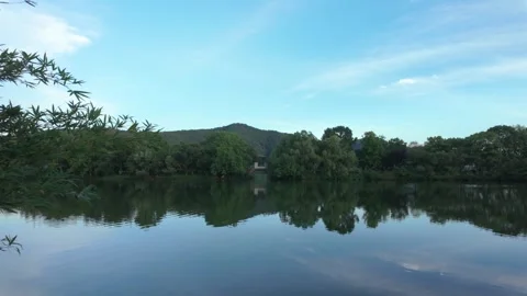 Scenic Calm Lake Reflection with Green Forest and Blue Sky Stock Footage 342497649
