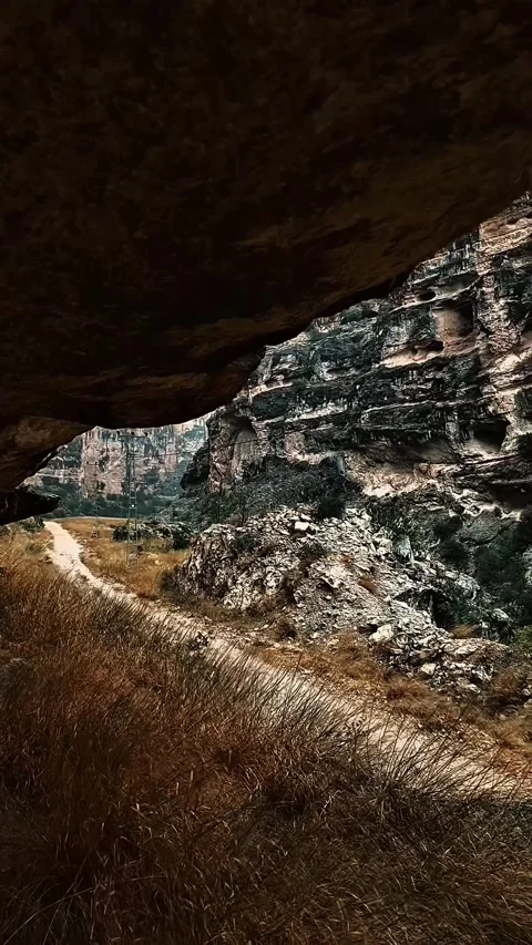 Scenic canyon path framed by a rocky overhang. Stock Footage 305659648