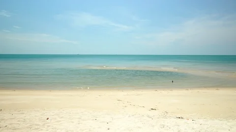 Scenic of the clean and clear ocean crashing to the tropical white sand beach Stock Footage
