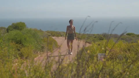 Scenic Cliffside Walk Overlooking the Ocean Stock Footage 315985690
