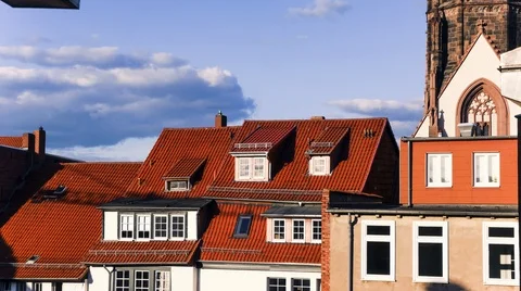 Scenic Clouds Drifting Above House Rooftops in Time-Lapse Stock Footage 121221936