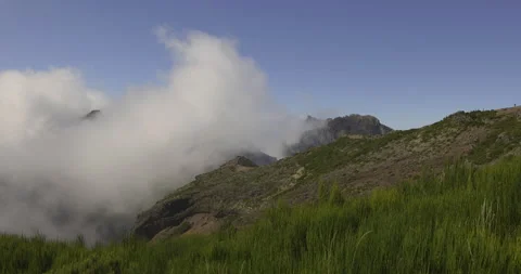 Scenic clouds fall on a mountain trail, Madeira, 4K Stock Footage 246382663