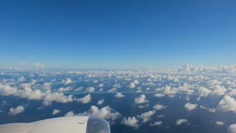 Scenic Clouds over tiny islands in Indian Ocean visible from an airplane Stock Footage 250883184