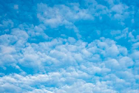 Scenic cloudscape of summer morning with clouds on blue sky Stock Photos
