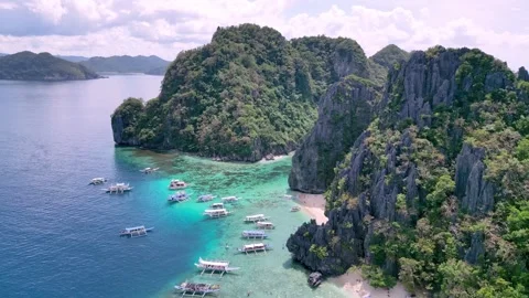 Scenic Coastal karst lagoon. Cliffs And Boats By Bay. Towering Rocks And Harbor Stock-Footage 339338094