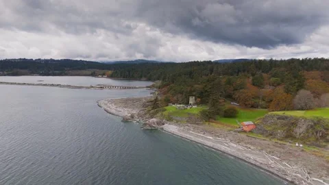 Scenic coastal landscape with dramatic clouds over a rocky shoreline Stock Footage 290497720