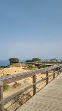 Scenic coastal landscape featuring rugged sandstone cliffs, a wooden boardwal Photos