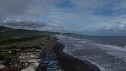 Scenic coastal landscape with waves gently rolling to the black sandy beach u Stock-Footage 306199352