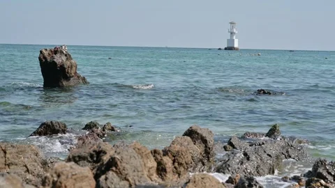 Scenic Coastal View with Lighthouse and Clear Blue Waters Stock Footage 296480034