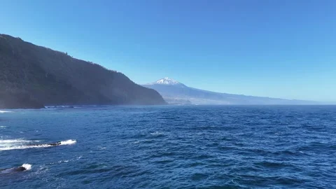 Scenic coastal view of ocean waves crashing against rocky shore with mist rising Stock Footage 330162854