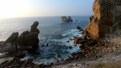 Scenic coastal view of rocky cliffs, ocean waves and the iconic sea stacks .. Stock Footage 343227479